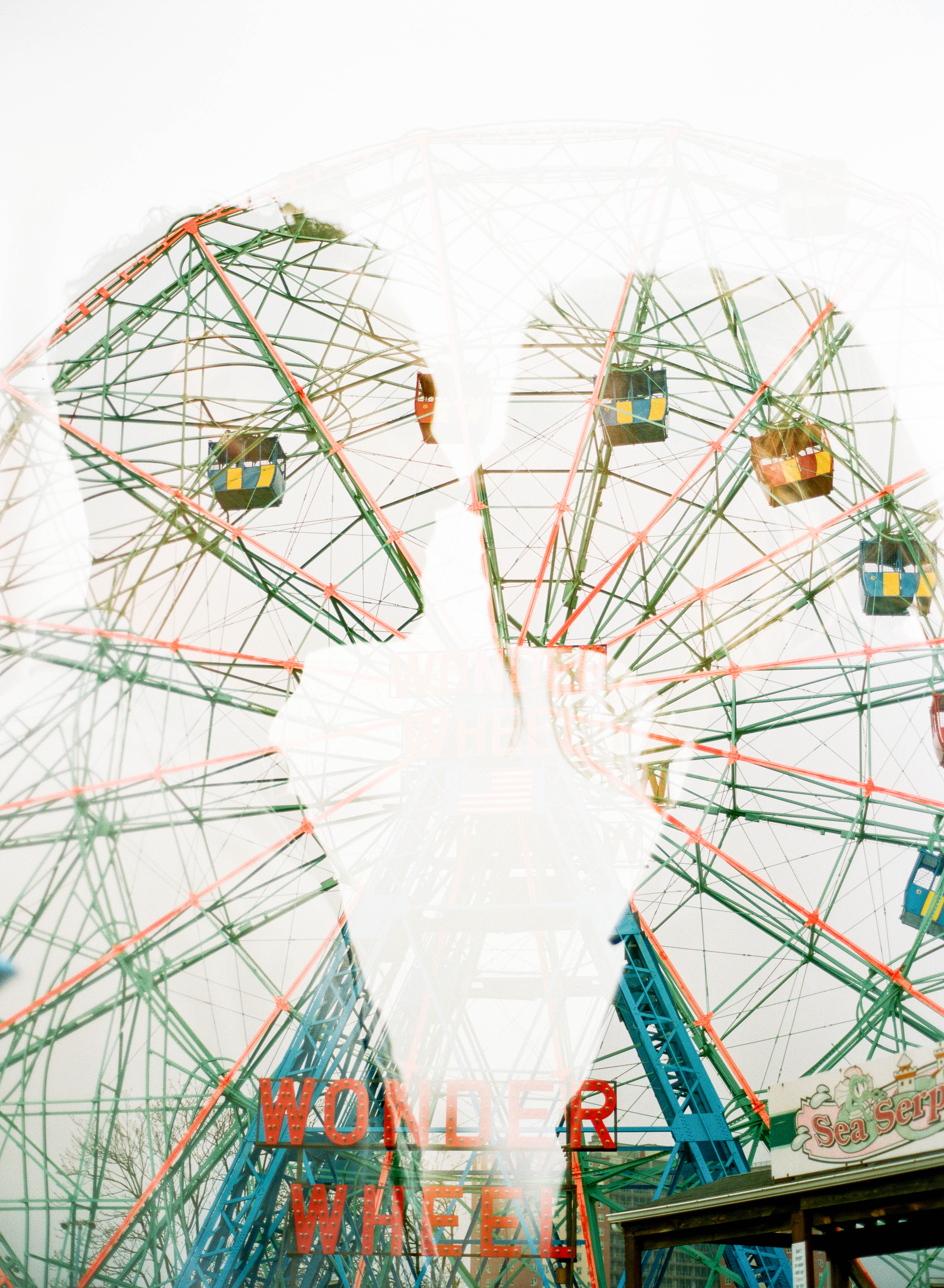 a double exposure of a bride and groom and a ferris wheel at coney island