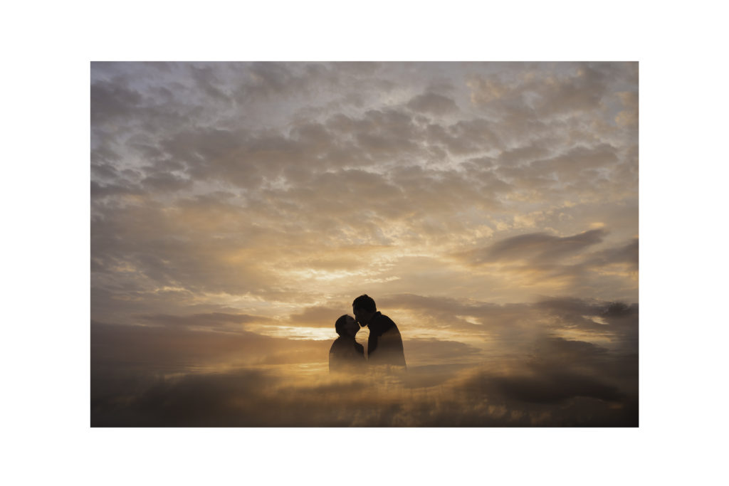 a silhouette of a couple at sunset