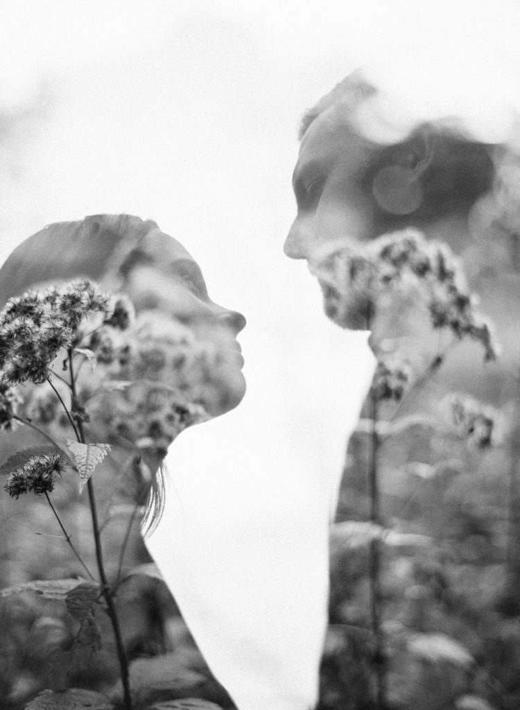 a couple's silhouette double exposed over flowers