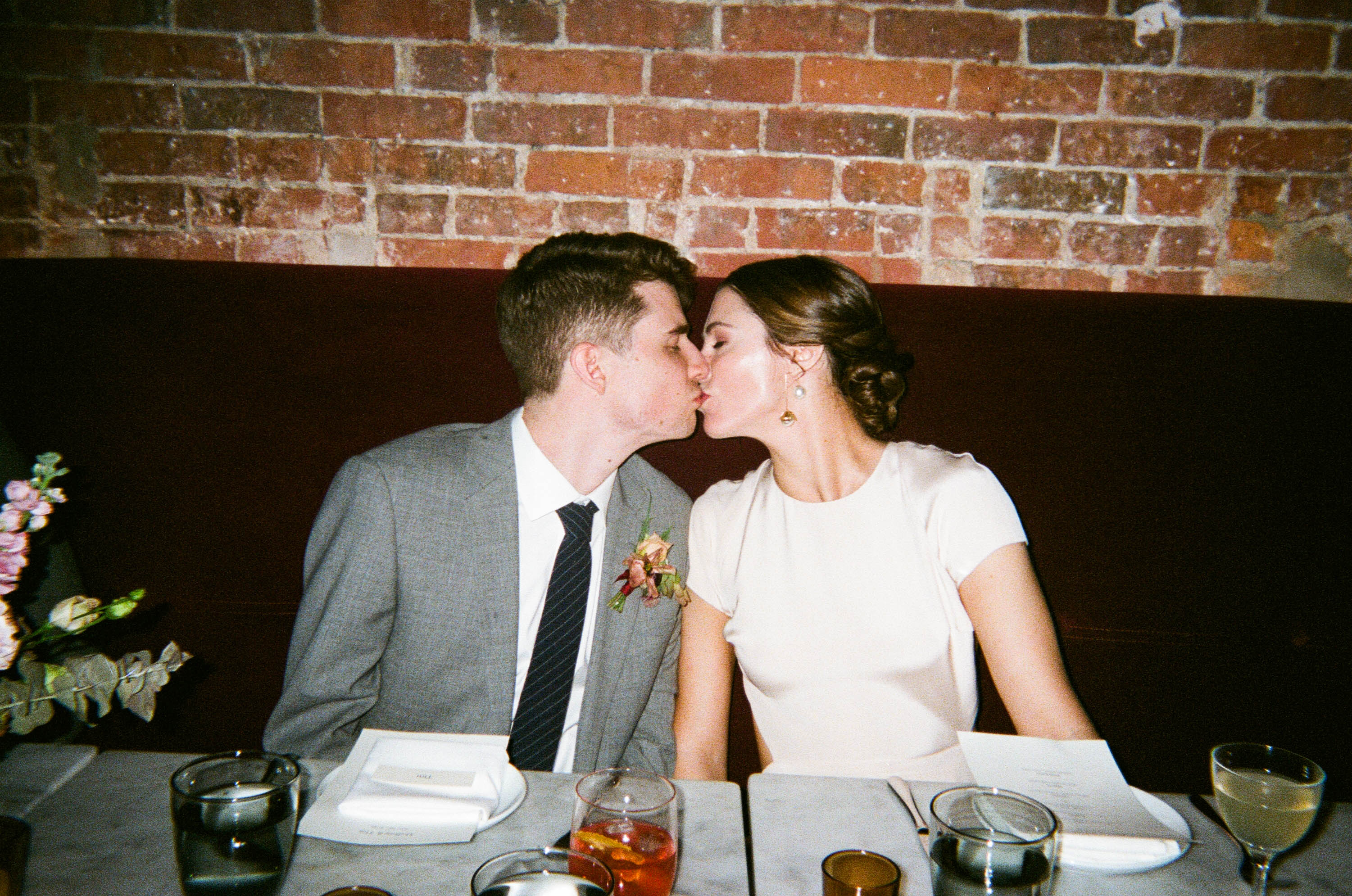 a bride and groom kissing at their wedding reception